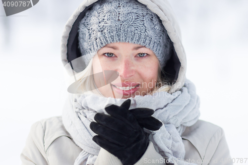 Image of Girl beeing cold outdoors in winter.