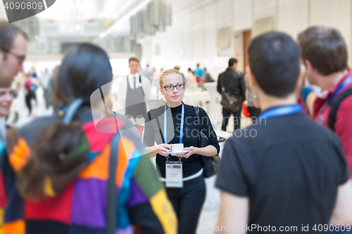 Image of People interacting during coffee break at medical conference.