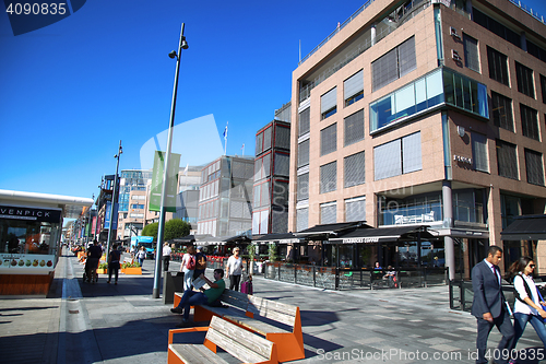 Image of OSLO, NORWAY – AUGUST 17, 2016: People walking on modern distr