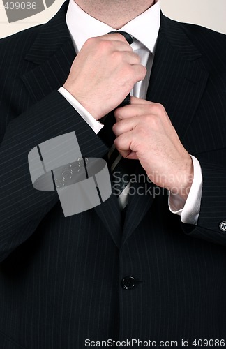 Image of Businessman adjusting his tie