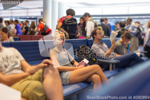 Image of Female backpacker waiting at airpot departure gates.