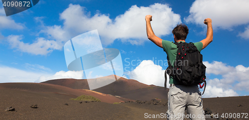 Image of Man reaching the top of mountain.