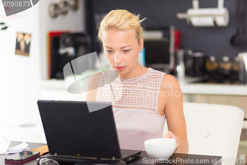 Image of Business woman working from home.