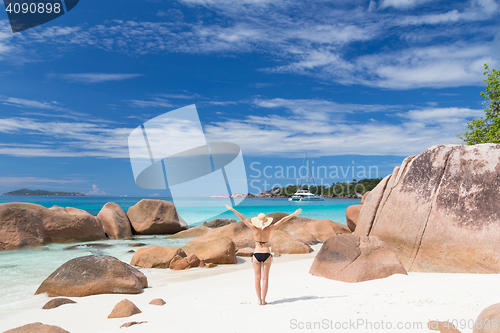 Image of Woman enjoying Anse Lazio picture perfect beach on Praslin Island, Seychelles.