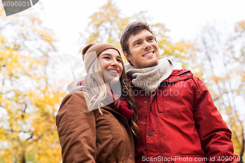 Image of happy young couple walking in autumn park