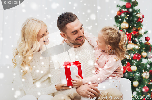 Image of happy family at home with christmas tree