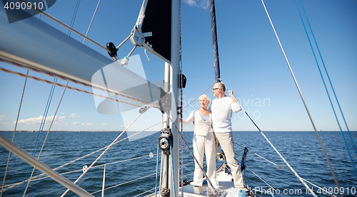 Image of senior couple hugging on sail boat or yacht in sea