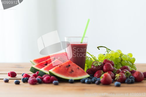 Image of fruit and berry juice or smoothie on wooden  table