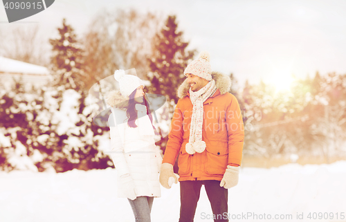 Image of happy couple walking over winter background