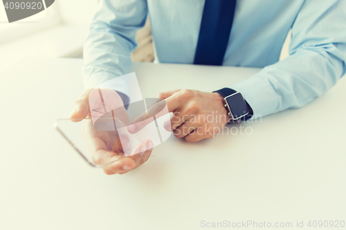 Image of close up of hands with smart phone and watch