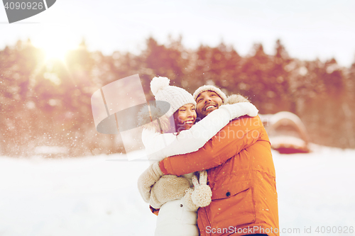 Image of happy couple hugging and laughing in winter