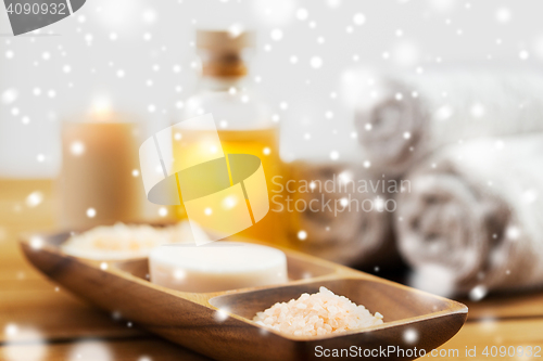 Image of soap, himalayan salt and scrub in wooden bowl