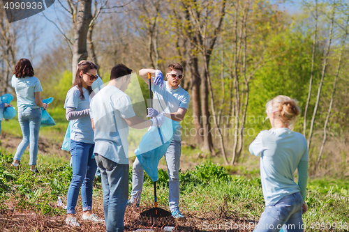 Image of volunteers with garbage bags cleaning park area