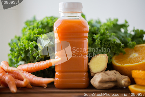 Image of bottle with carrot juice, fruits and vegetables