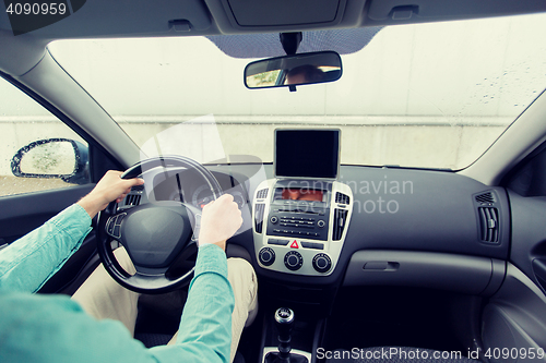 Image of close up of young man with tablet pc driving car