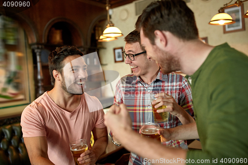 Image of football fans or friends with beer at sport bar