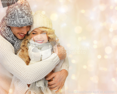 Image of happy family couple in winter clothes hugging