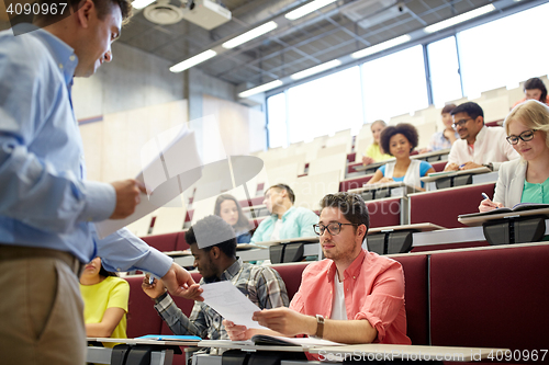 Image of teacher giving tests to students at lecture