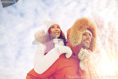 Image of happy couple having fun over winter background