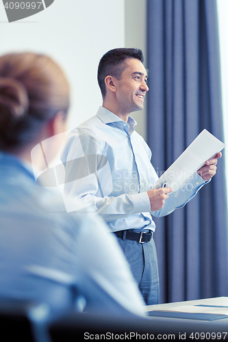 Image of smiling businesspeople meeting in office