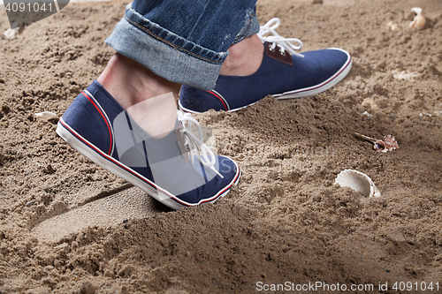 Image of Man\'s Legs And Footprint On The Sand