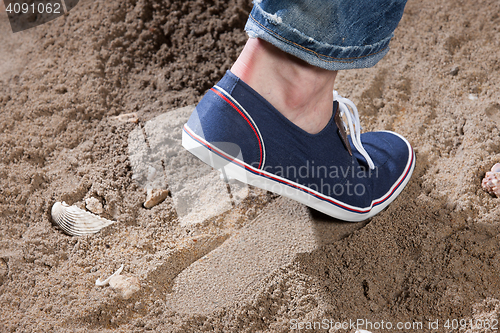 Image of Man\'s Legs And Footprint On The Sand