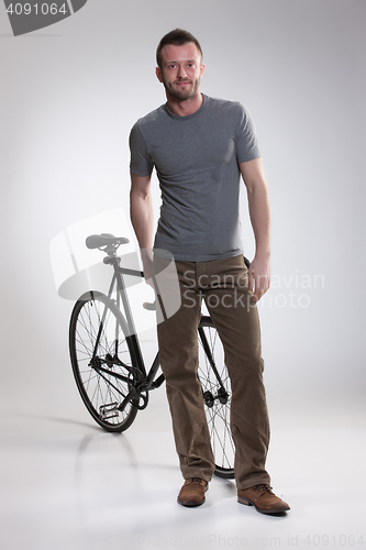 Image of Young Man And Bicycle
