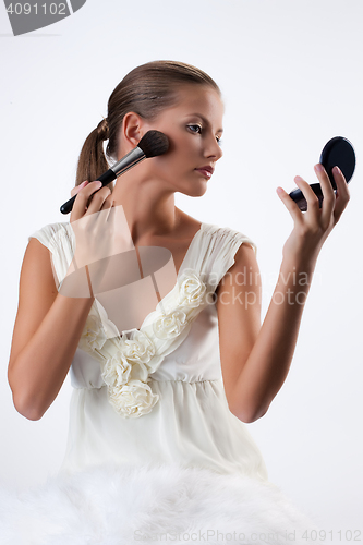 Image of Young Woman Applying Cosmetics