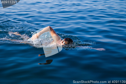 Image of Man swimming in blue water