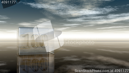 Image of number one hundred in glass cube under cloudy sky - 3d rendering