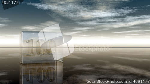 Image of number one hundred in glass cube under cloudy sky - 3d rendering