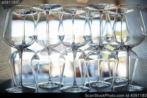 Image of empty wine glasses set on shelf at restaurant