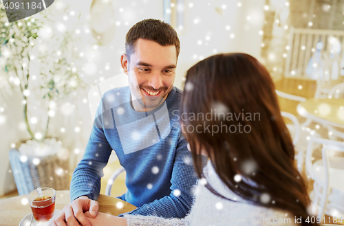 Image of happy couple drinking tea at cafe