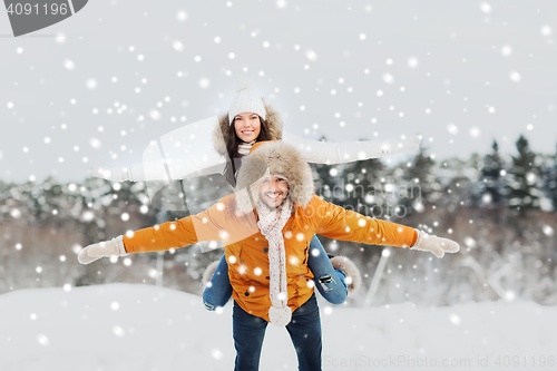 Image of happy couple having fun over winter background