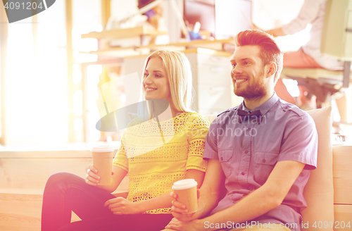 Image of happy man and woman drinking coffee in office