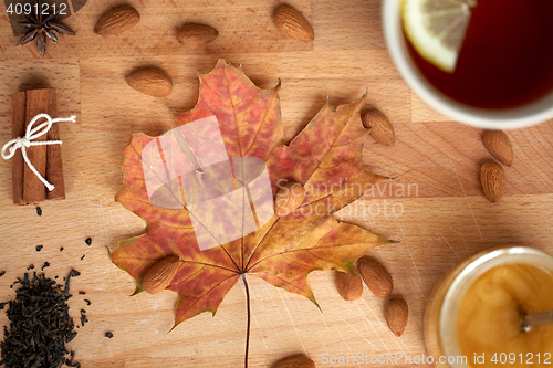 Image of cup of lemon tea and honey on wooden board