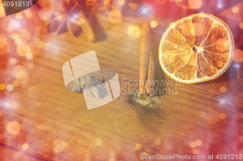 Image of cinnamon, anise and dried orange on wooden board