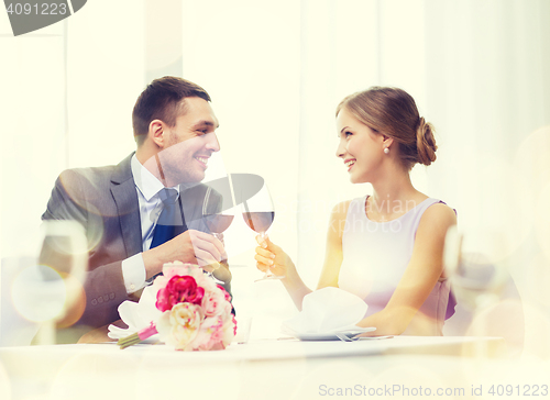 Image of young couple with glasses of wine at restaurant