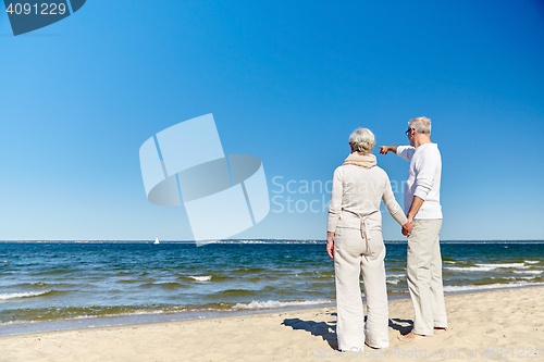 Image of happy senior couple on summer beach