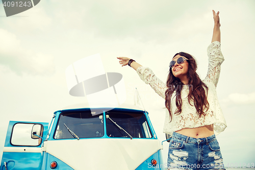 Image of smiling young hippie woman in minivan car