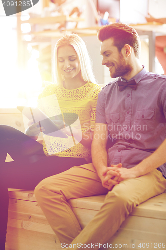 Image of happy creative team with tablet pc in office