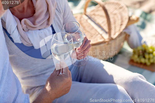 Image of happy senior couple having picnic on summer beach
