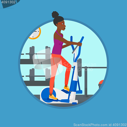 Image of Woman exercising on elliptical trainer.