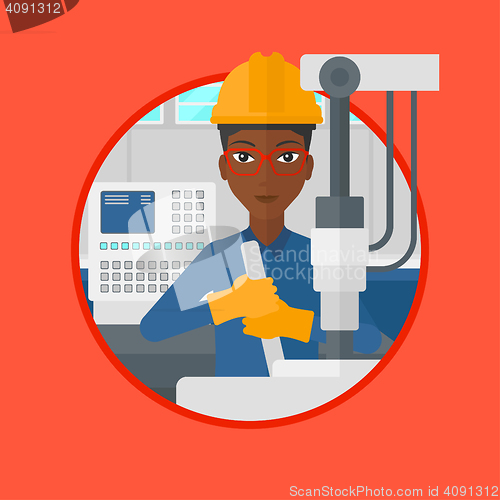 Image of Woman working on industrial drilling machine.