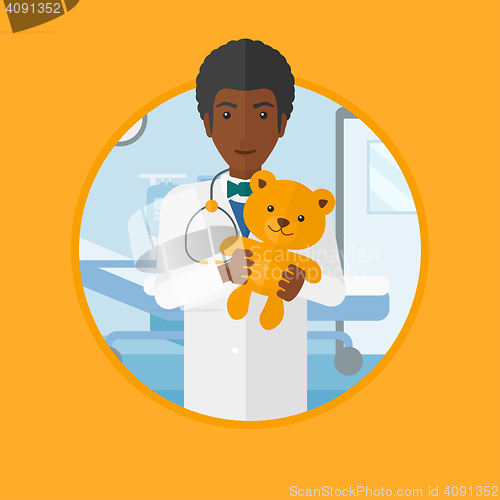 Image of Pediatrician doctor holding teddy bear.