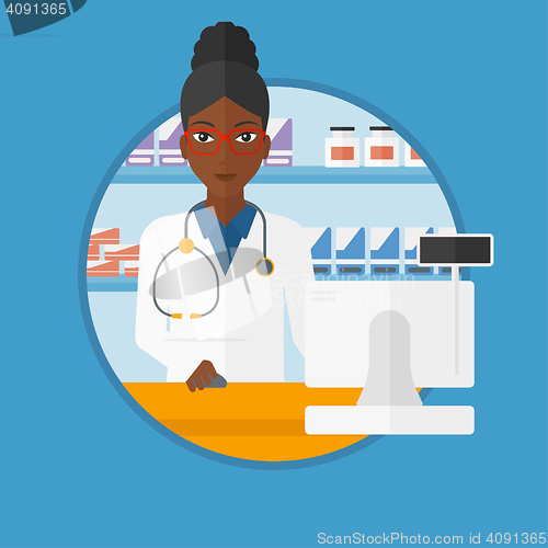 Image of Pharmacist at counter with computer monitor.