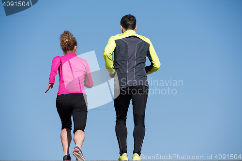 Image of young  couple jogging on steps