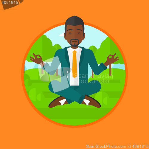 Image of Businessman meditating in lotus position.