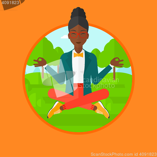 Image of Business woman meditating in lotus position.