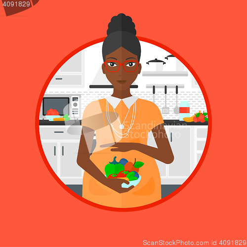 Image of Pregnant woman with vegetables and fruits.